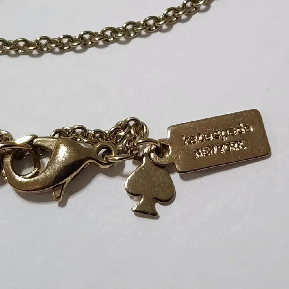 KATE SPADE hole punch Ace necklace white and gold tone‎